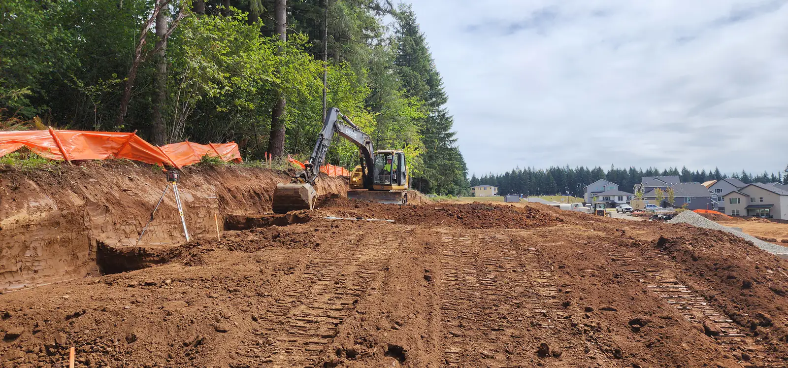 LPG excavator digging a building pad in a new subdivision