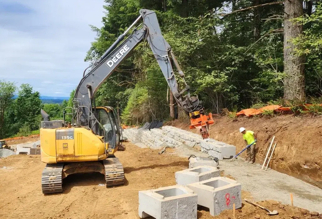 LPG's Deere 135G excavator setting units for a retaining wall